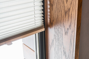 Wooden slopes on the window. Window with pleated shades - 357568669