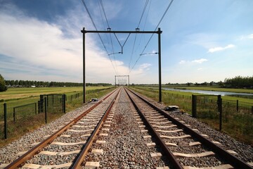 Railroad track until the horizon at Moordrecht between the cities of Gouda and Rotterdam.