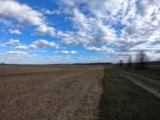 Naklejka premium Blue sky with white clouds over farmland. Landscape.