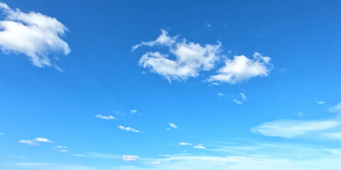 White clouds on a blue sky as a background. Sunny weather.