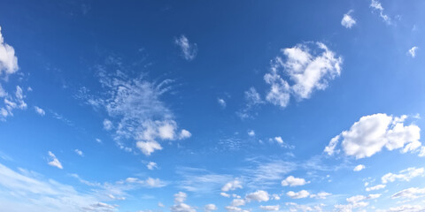 Fototapeta na wymiar White clouds on a blue sky as a background. Sunny weather.