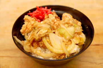 Japanese food katsudon with onions and red ginger on rice bowl