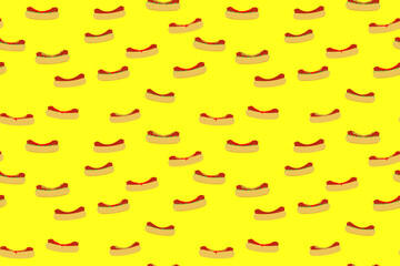 Seamless pattern in yellow with hot dogs. For printing on fabric, packaging or as a backing on a street food web site