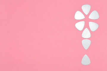 Bright pink background with an empty place for text and an exclamation mark made of guitar picks