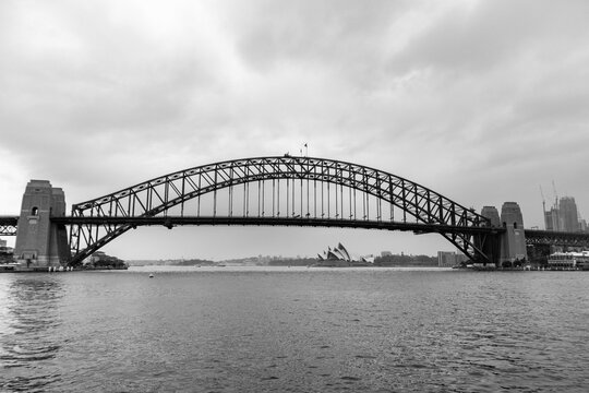 Black and white panoramic picture of the Harbour bridge and Sydney Opera house. View from the public ferry boat. Sydney, Australia