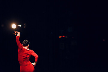 Flamenco woman dancer in red traditional costume dress. Flamenco spanish dance on stage. - obrazy, fototapety, plakaty
