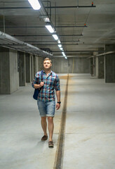 Fit young man walking through a concrete basement
