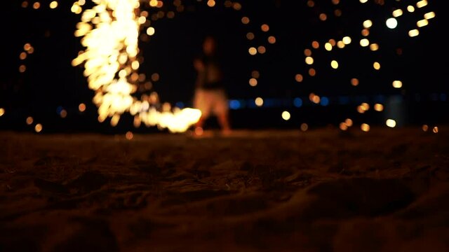 Slow motion steel wool fire dancing on the beach summer night time holiday, Mui Ne, Phan Thiet, Binh Thuan, Vietnam