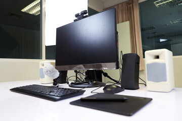 Fototapeta premium Desktop computer for online class education at school or university. Computer set for online learning with microphone, webcam, speaker and pen tablet.