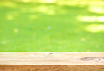 Blank wood board with blur green courtyard background.Summer and picnic concepts