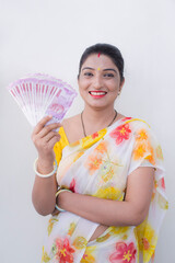 Happy young woman holding Indian 2000 rupees 