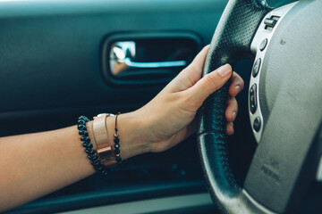 woman hands on steering wheel close up