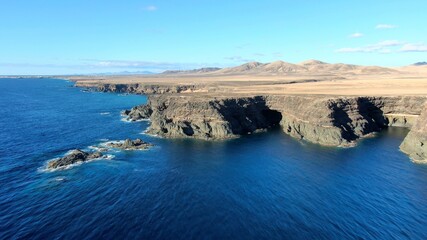 on the cliffs by the sea and the mountains watching the sunset