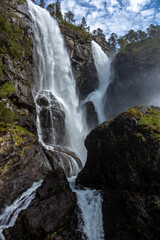 Hesjedalsfossen with blue sky and cascading water