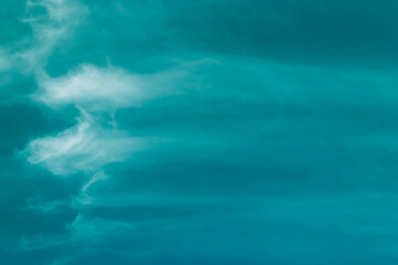 Fototapeta na wymiar Blue background with light wispy, smokey clouds