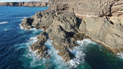 on the cliffs by the sea and the mountains watching the sunset