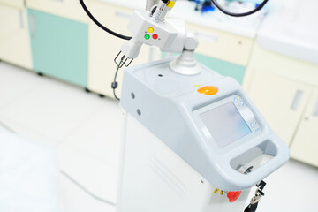 modern device for skin rejuvenation-fractional laser close-up on the background of a cosmetology clinic
