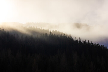 Beautiful foggy sunrise on mountain ridge in the Alps