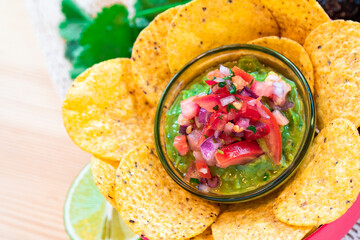 Mexican homemade Guacamole avocado corn nachos chip and tomato salad