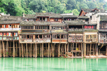 Old authentic Chinese wooden riverside houses on stilts