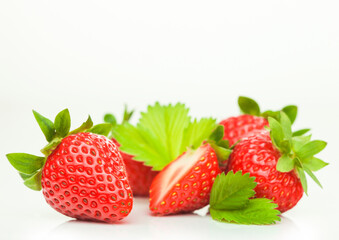 Fresh raw organic strawberries with leaf on white background.