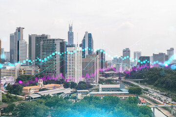Fototapeta premium Forex and stock market chart hologram over panorama city view of Kuala Lumpur. KL is the financial center in Malaysia, Asia. The concept of international trading. Double exposure.