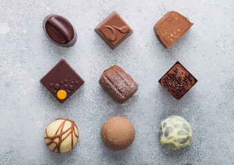 Luxury Chocolate candies selection on light table background.White, dark and milk chocolate...