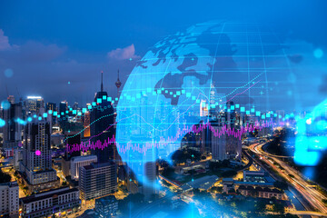 FOREX graph hologram, aerial night panoramic cityscape of Kuala Lumpur. KL is the developed location for stock market researchers in Malaysia, Asia. The concept of fundamental analysis.