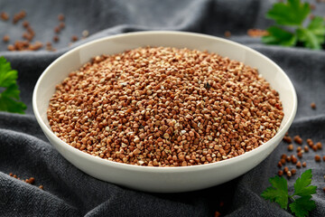 Organic roasted Buckwheat groats in white bowl. healthy vegetarian food