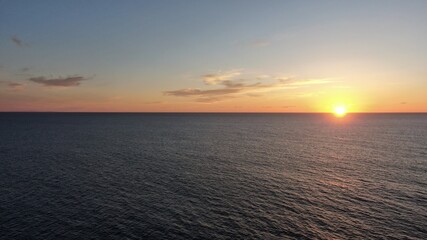 on the cliffs by the sea and the mountains watching the sunset