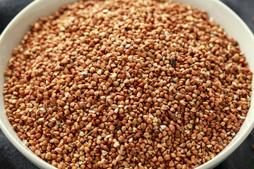 Organic roasted Buckwheat groats in white bowl. healthy vegetarian food