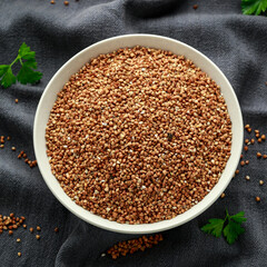 Organic roasted Buckwheat groats in white bowl. healthy vegetarian food