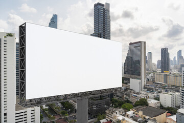 Obraz premium Blank white road billboard with Bangkok cityscape background at day time. Street advertising poster, mock up, 3D rendering. Side view. The concept of marketing communication to promote or sell idea.
