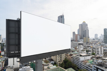 Blank white road billboard with Bangkok cityscape background at day time. Street advertising poster, mock up, 3D rendering. Side view. The concept of marketing communication to promote or sell idea.