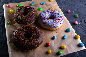 Donuts on a wooden board on a blue concrete background