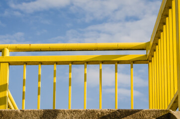 Yellow metal guardrail on the bridge 