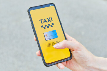 Concept of paying online by credit card taxi in the application on a smartphone.