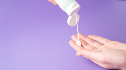 Hand cream. Pouring lotion from tube on hand. Body cream drop on hand. Body care. moisturizing cream. Isolated