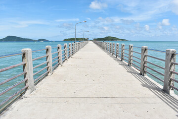 Cement docks with blue sky. The cement bridge, the jetty stretches into the sea in the afternoon.