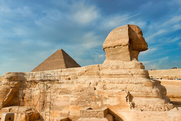Fototapeta na wymiar The Great Sphinx of Giza and one of the famoust pyramids in Egypt
