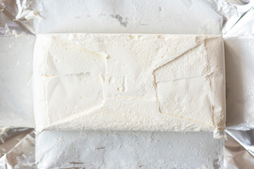 Close-up foil pack and frozen white ice cream, top view