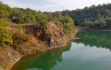 Place after human intervention. Old flooded iron ore quarry. Beauty of nature