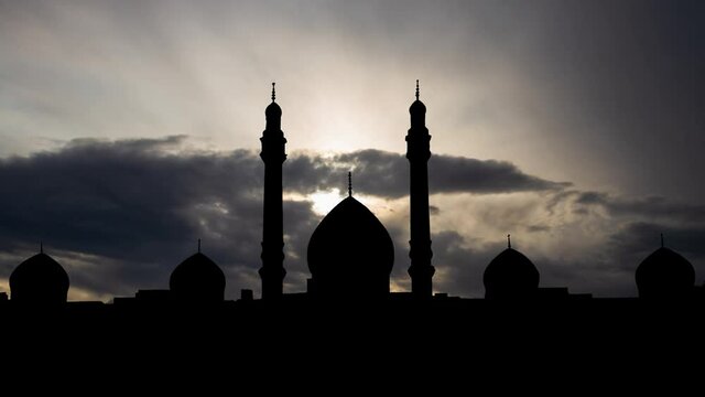 Imam Mahdi Jamkaran Mosque,Time Lapse at Sunrise with Fast Clouds and Dark Silhouette of Domes and Minarets, Qom, Iran