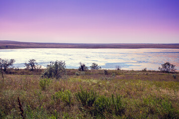 Beautiful wilderness. Salt lake in a steppe. Nature landscape. Lakeshore on a sunny day