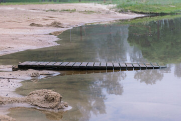 sandy beach after heavy rain, white fog on the lake, fuzzy contours
