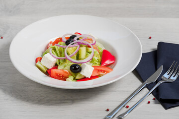 White plate with vegetable salad 