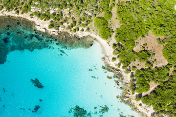 View from above, stunning aerial view of a rocky coastline bathed by a beautiful turquoise sea. Cala Sabina, Costa Smeralda, Sardinia, Italy.