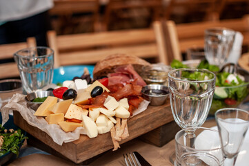 Slicing different varieties of cheese and meat