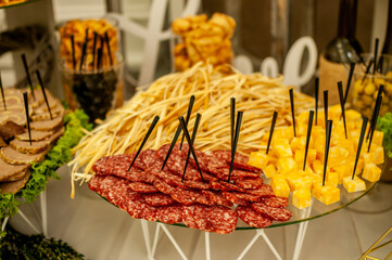 Slicing different varieties of cheese and meat