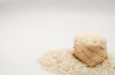 Fototapeta na wymiar rice in basket on white background, copy space